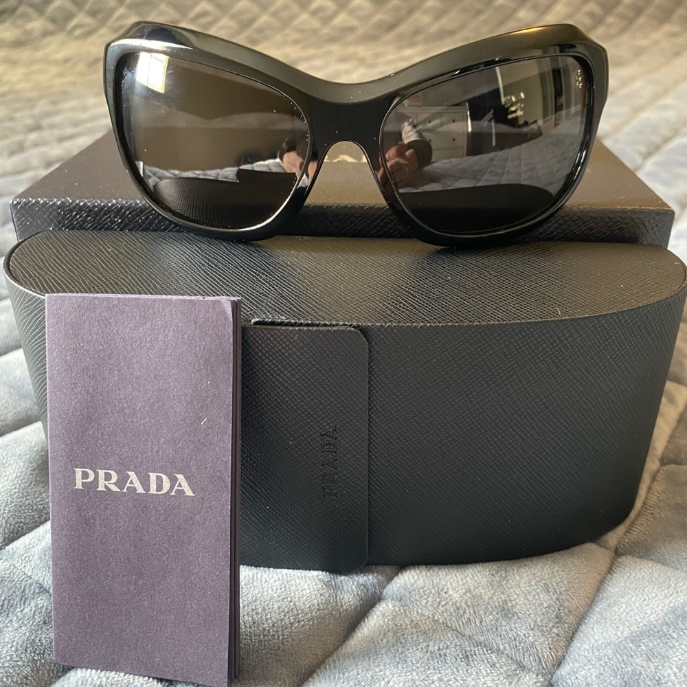 Brand new Prada sunglasses. Box and case included. Signature butterfly shape .